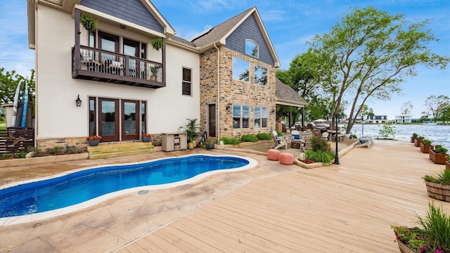 11290 Honeycreek Rd NW, Thornville, OH 43076 - back of property featuring french doors, stucco siding, an outdoor pool, a balcony, and a water view