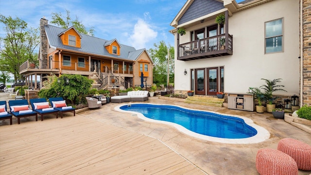 11290 Honeycreek Rd NW, Thornville, OH 43076 - back of house with outdoor lounge area, french doors, a balcony, an outdoor pool, and stucco siding
