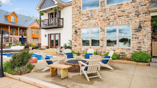 11290 Honeycreek Rd NW, Thornville, OH 43076 - view of patio / terrace with french doors, a balcony, an outdoor pool, and a fire pit