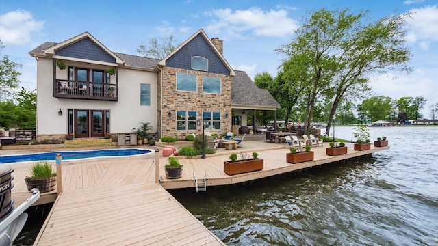 11290 Honeycreek Rd NW, Thornville, OH 43076 - back of property with french doors, a balcony, a water view, stucco siding, and a patio area