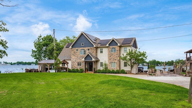 11290 Honeycreek Rd NW, Thornville, OH 43076 - view of front facade with a gazebo, solar panels, a front lawn, stone siding, and a water view