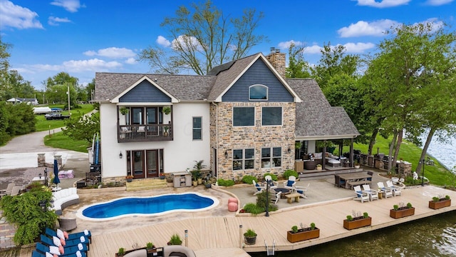11290 Honeycreek Rd NW, Thornville, OH 43076 - back of property with a balcony, an outdoor pool, stucco siding, a chimney, and french doors