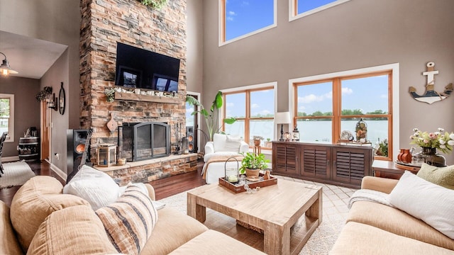 11290 Honeycreek Rd NW, Thornville, OH 43076 - living room featuring wood finished floors, a fireplace, and a towering ceiling