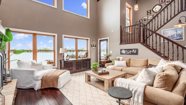 11290 Honeycreek Rd NW, Thornville, OH 43076 - living area featuring hardwood / wood-style flooring, healthy amount of natural light, stairs, a high ceiling, and a water view