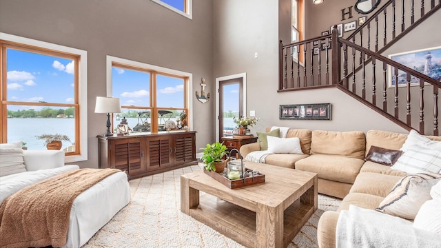 11290 Honeycreek Rd NW, Thornville, OH 43076 - living area featuring a towering ceiling, stairs, plenty of natural light, and a water view