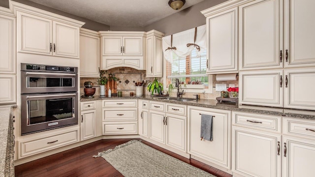 11290 Honeycreek Rd NW, Thornville, OH 43076 - kitchen with double oven, a sink, cream cabinetry, and a textured ceiling