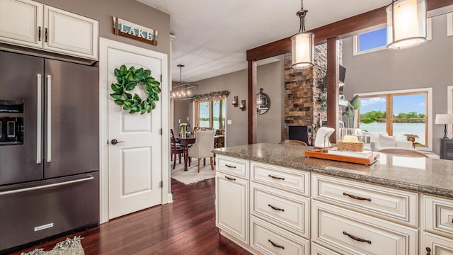 11290 Honeycreek Rd NW, Thornville, OH 43076 - kitchen with high end fridge, cream cabinetry, stone counters, dark wood-style floors, and hanging light fixtures