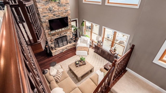 11290 Honeycreek Rd NW, Thornville, OH 43076 - living area with a fireplace, a towering ceiling, and baseboards