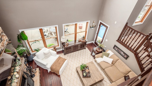 11290 Honeycreek Rd NW, Thornville, OH 43076 - living area with a high ceiling, wood-type flooring, baseboards, and stairway