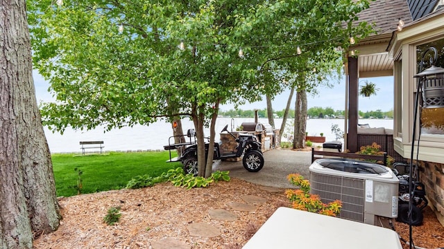 11290 Honeycreek Rd NW, Thornville, OH 43076 - view of patio / terrace featuring central AC and a water view