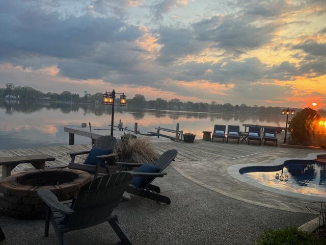 11290 Honeycreek Rd NW, Thornville, OH 43076 - view of patio / terrace featuring a fire pit, a dock, an outdoor pool, and a water view