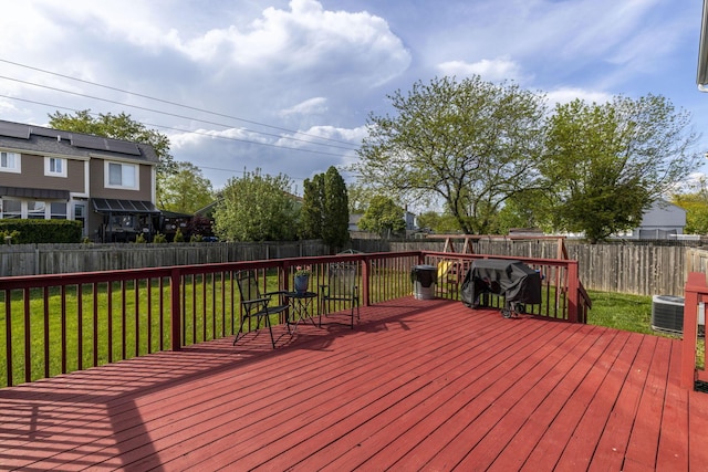 wooden deck featuring a yard, a fenced backyard, area for grilling, and central air condition unit