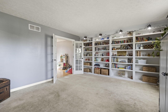 interior space with visible vents and french doors