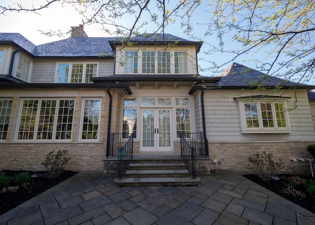 2528 Onandaga Dr, Upper Arlington, OH 43221 - rear view of property featuring french doors, stone siding, a chimney, and a patio