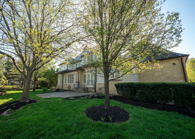 2528 Onandaga Dr, Upper Arlington, OH 43221 - back of property with stone siding, a patio, and a yard