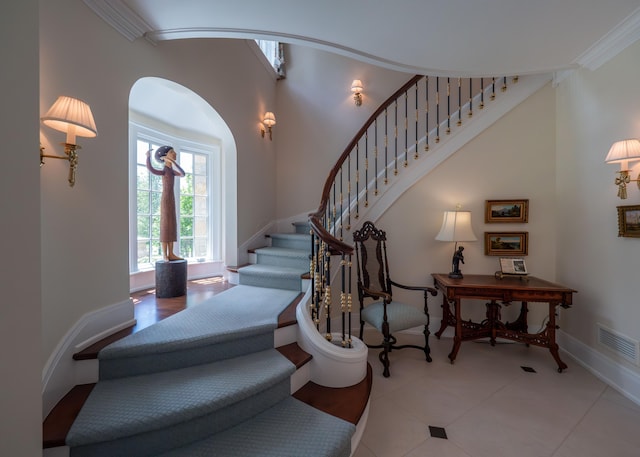 2528 Onandaga Dr, Upper Arlington, OH 43221 - staircase with arched walkways, crown molding, tile patterned floors, and baseboards