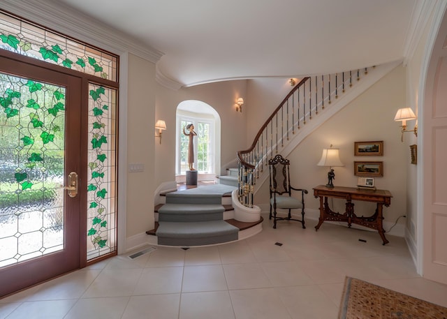 2528 Onandaga Dr, Upper Arlington, OH 43221 - entryway featuring stairs, arched walkways, baseboards, crown molding, and tile patterned floors