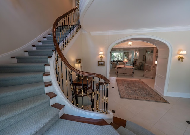 2528 Onandaga Dr, Upper Arlington, OH 43221 - staircase featuring arched walkways, crown molding, tile patterned flooring, and baseboards