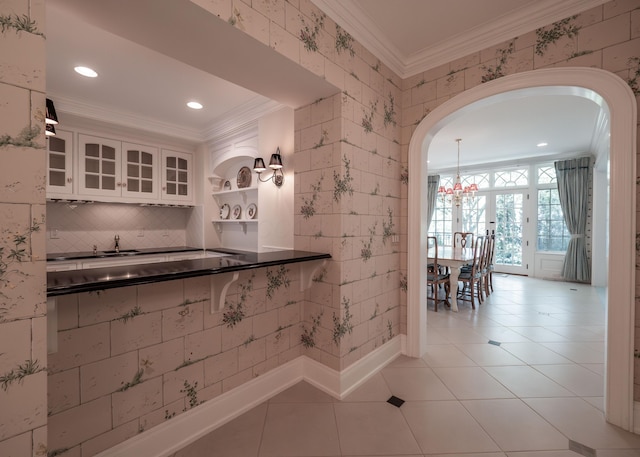 2528 Onandaga Dr, Upper Arlington, OH 43221 - kitchen with crown molding, arched walkways, white cabinetry, recessed lighting, and dark countertops