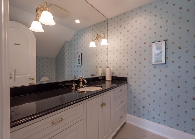 2528 Onandaga Dr, Upper Arlington, OH 43221 - bathroom with wallpapered walls, vaulted ceiling, vanity, tile patterned flooring, and baseboards