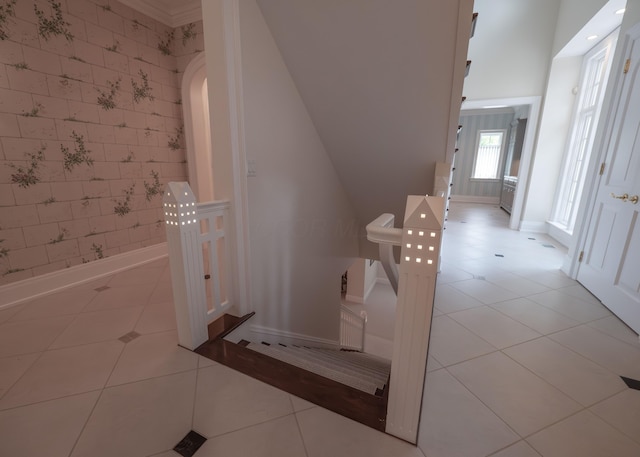 2528 Onandaga Dr, Upper Arlington, OH 43221 - stairs with wallpapered walls, tile patterned floors, baseboards, and arched walkways