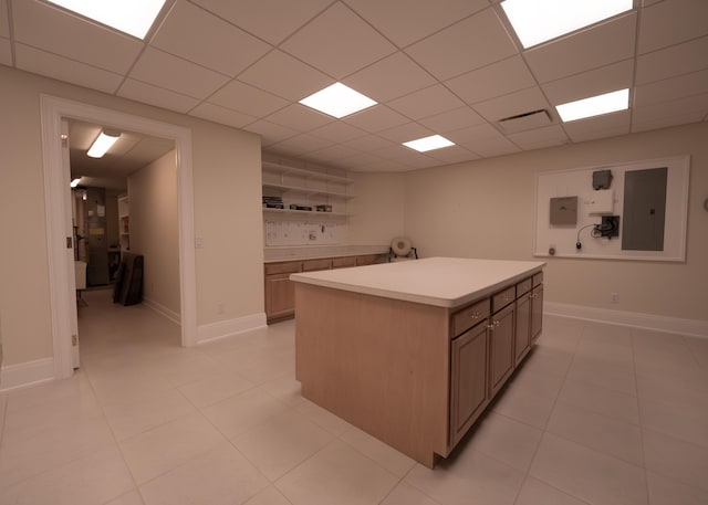 2528 Onandaga Dr, Upper Arlington, OH 43221 - kitchen featuring light countertops, a kitchen island, a drop ceiling, electric panel, and light tile patterned floors