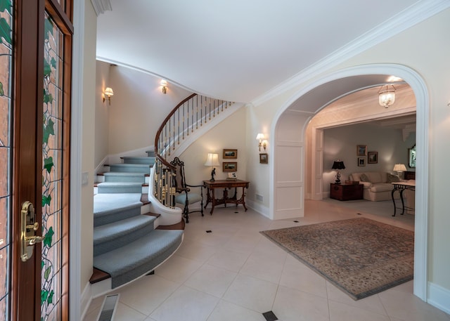2528 Onandaga Dr, Upper Arlington, OH 43221 - tiled entryway featuring stairs, arched walkways, crown molding, and baseboards