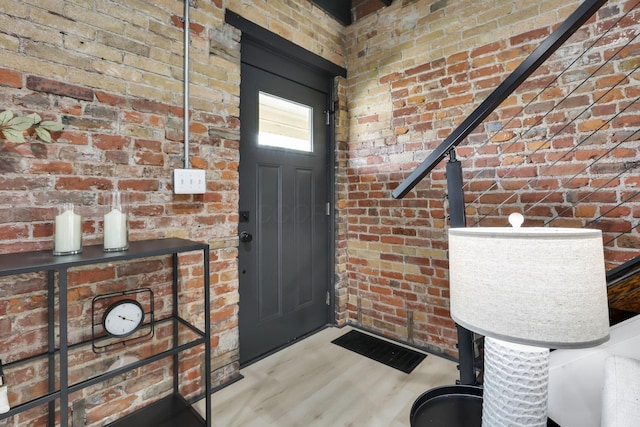 1010 Bruck St, Columbus, OH 43206 - foyer entrance featuring brick wall and wood finished floors