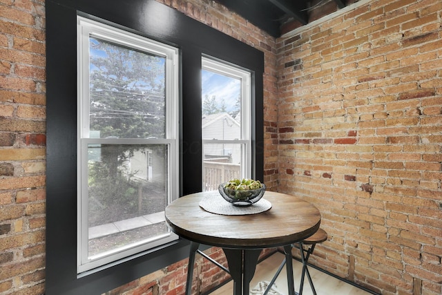 1010 Bruck St, Columbus, OH 43206 - dining space featuring wood finished floors and brick wall