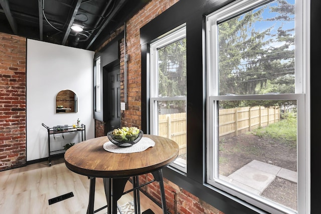 1010 Bruck St, Columbus, OH 43206 - dining area featuring brick wall and wood finished floors