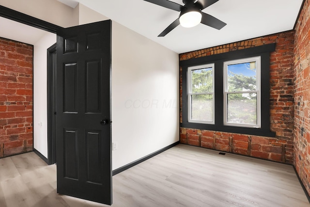 1010 Bruck St, Columbus, OH 43206 - interior space featuring baseboards, light wood-style flooring, and brick wall