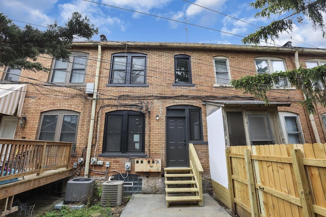 1010 Bruck St, Columbus, OH 43206 - townhome / multi-family property with entry steps, fence, cooling unit, and brick siding