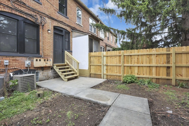 1010 Bruck St, Columbus, OH 43206 - property entrance with brick siding, fence, and cooling unit