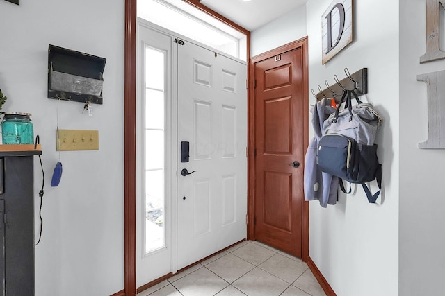entrance foyer featuring light tile patterned floors and baseboards