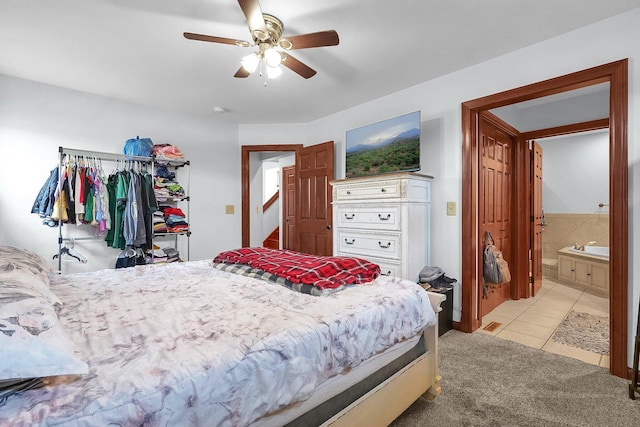 bedroom featuring ceiling fan, light carpet, and light tile patterned flooring