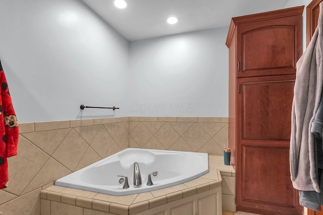 full bathroom with a garden tub and recessed lighting