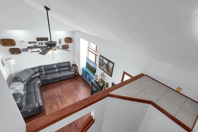 living room with vaulted ceiling, wood finished floors, and a ceiling fan