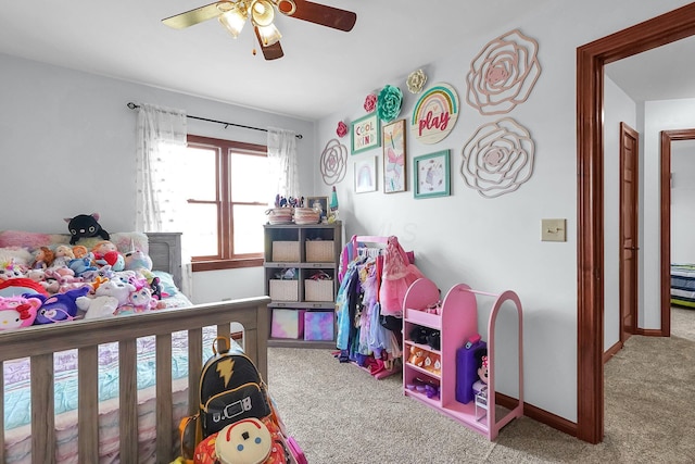 carpeted bedroom featuring baseboards and ceiling fan