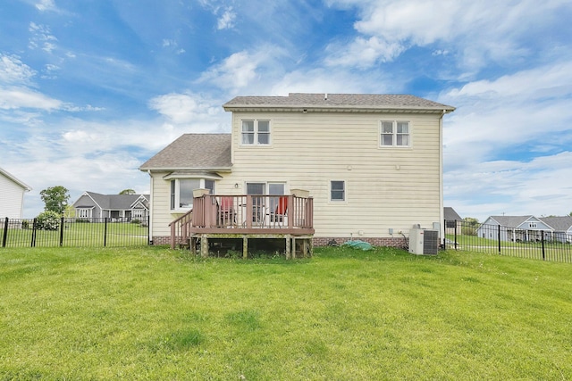 rear view of property with a yard, a wooden deck, and a fenced backyard
