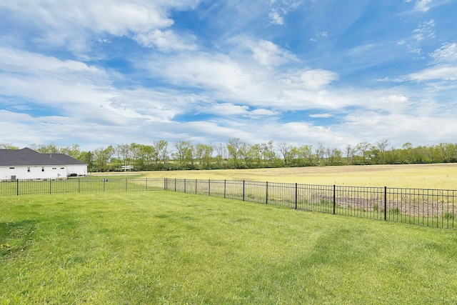 view of yard with a rural view and fence