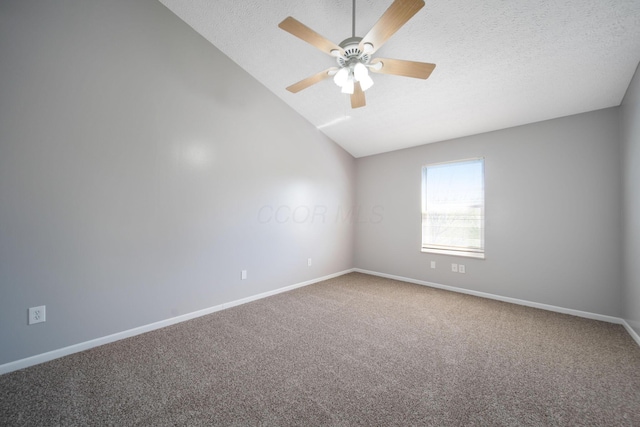 carpeted empty room featuring baseboards, a ceiling fan, a textured ceiling, and vaulted ceiling