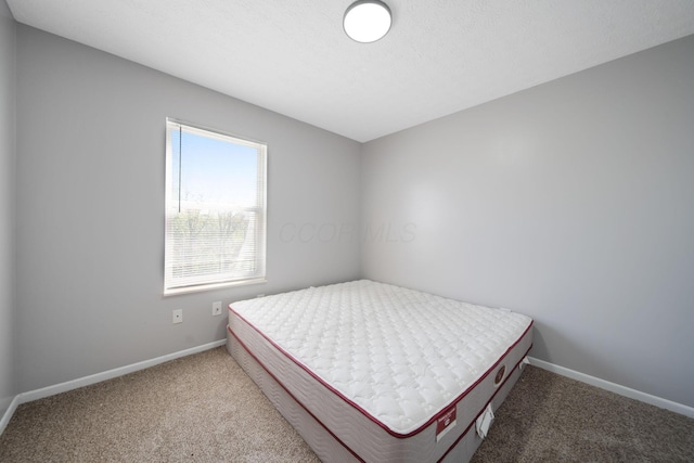 carpeted bedroom featuring baseboards