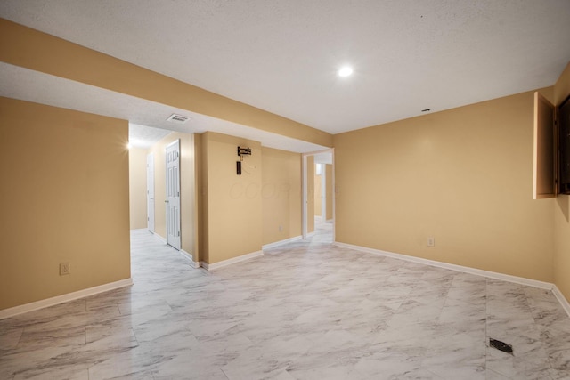 empty room featuring baseboards, visible vents, and marble finish floor