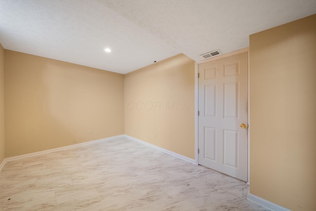empty room featuring recessed lighting, baseboards, marble finish floor, and visible vents