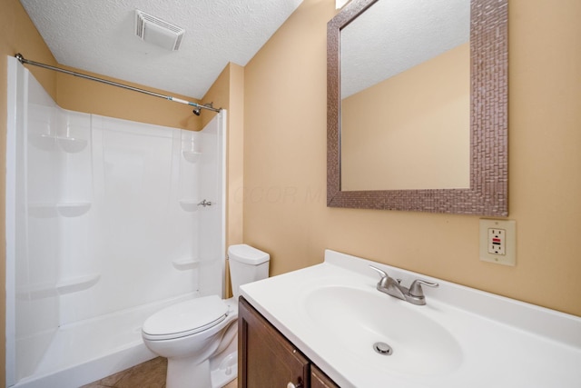 full bathroom with vanity, toilet, visible vents, and a shower