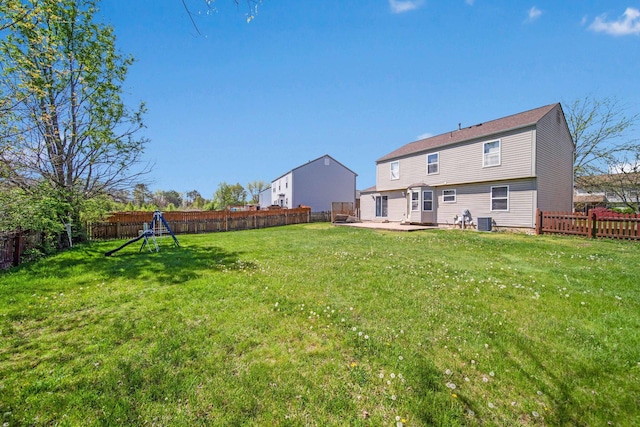 view of yard with a patio, central AC unit, and a fenced backyard