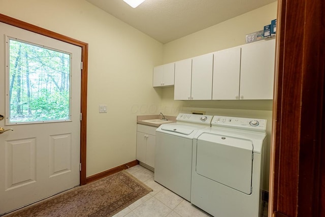 8884 Filiz Ln, Powell, OH 43065 - laundry area with cabinet space, independent washer and dryer, healthy amount of natural light, and light tile patterned flooring