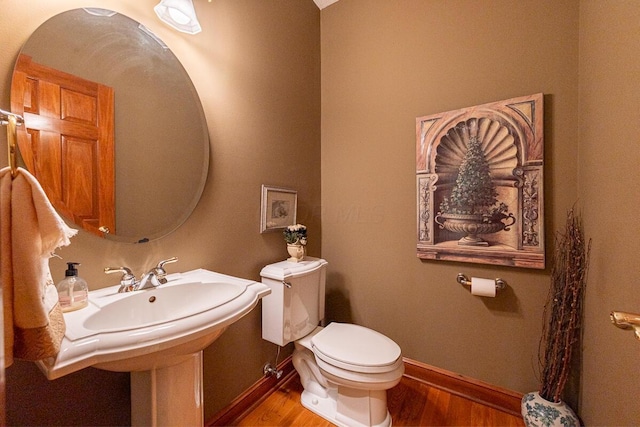 8884 Filiz Ln, Powell, OH 43065 - bathroom featuring wood finished floors, toilet, and baseboards