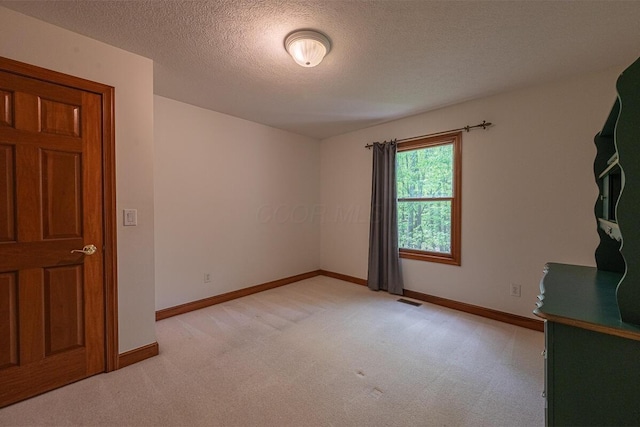 8884 Filiz Ln, Powell, OH 43065 - unfurnished room with light colored carpet, a textured ceiling, and baseboards