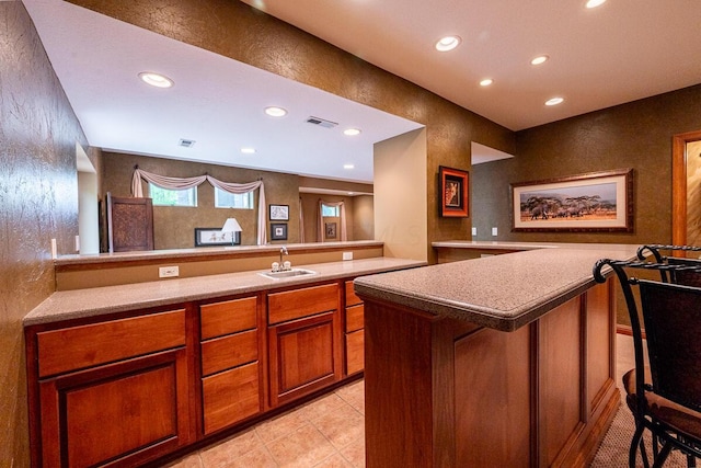 8884 Filiz Ln, Powell, OH 43065 - bar area featuring a sink, recessed lighting, and light tile patterned floors